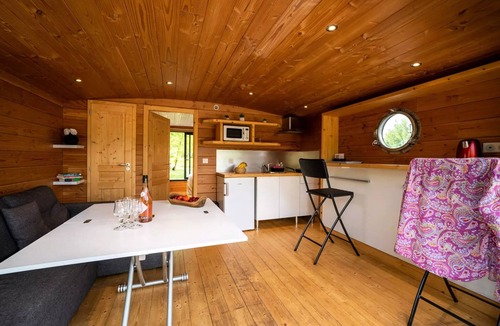 Molinet Cabin | A small boat moored at the dock, 5 people