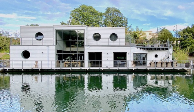 Countryside in Paris An architect house like an island facing water and nature.