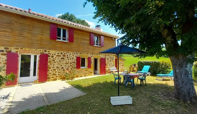 House in the countryside, with large expanses of woods and fields.