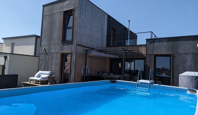 Newly built house with a view of the sea and a heated above-ground pool